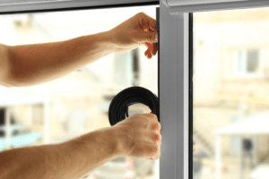 Technician hands installing trim and repairing window