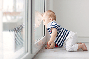 Baby looking through Glass window